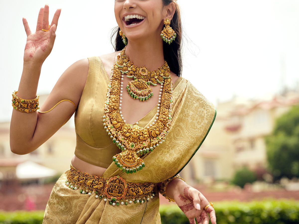 Bride laughing in temple gold